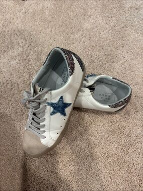 Shu Shop suede, and denim star with rainbow glitter on the back.